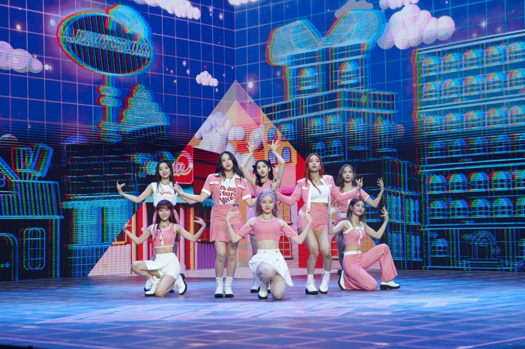 Still of Cube Entertainment's LIGHTSUM, an 8-member K-pop girl group dressed in pink and white checkered outfits while performing single "Vanilla" during their June 10 Debut Showcase.
