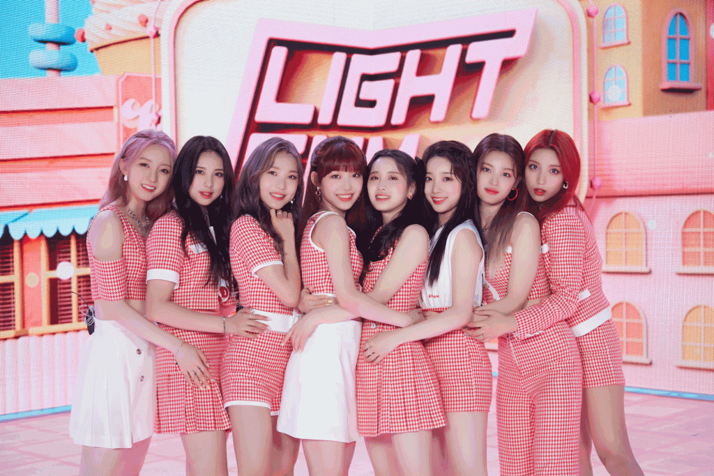 Image of Cube Entertainment's LIGHTSUM, an 8-member K-pop girl group dressed in pink and white checkered outfits and standing close together during their June 10 Debut Showcase.
