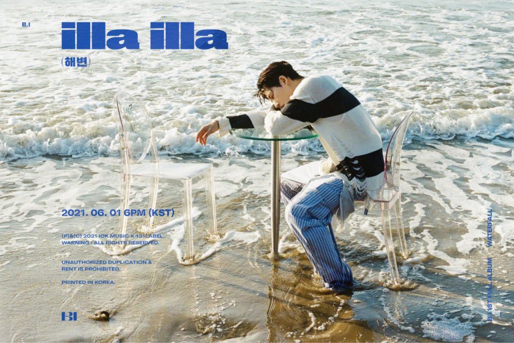 Solo singer and artist B.I sitting on a chair and laying his body on a table in the middle of the beach for his "illa illa" official concept photo under IOK Music x 131LABEL