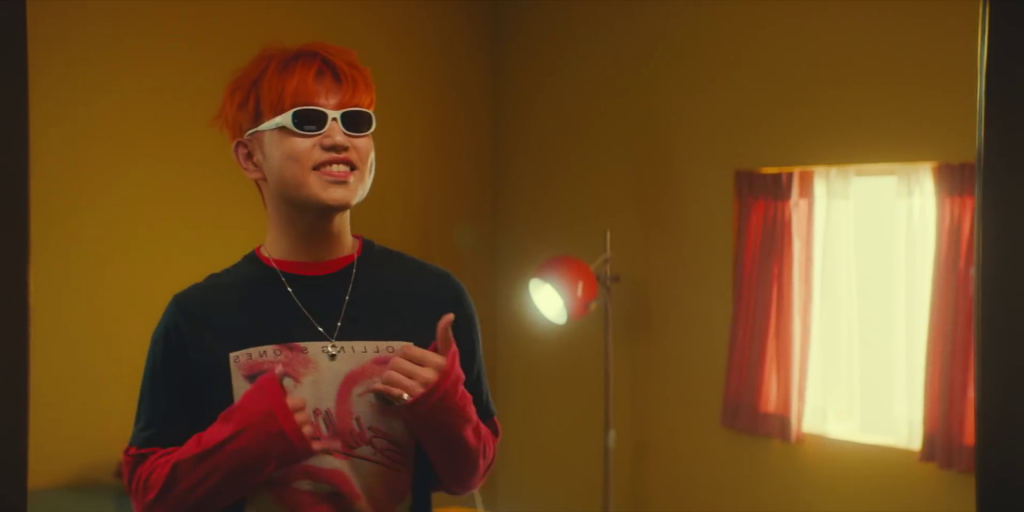 Singer Sam Kim wearing sunglasses and having fun in his music video for his song, "The Juice."