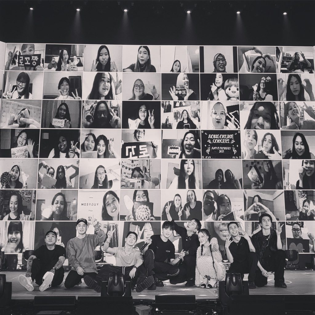 AOMG's Woo, Gray, Loco, Yugyeom, LeeHi, and Simon Dominic posing in front of fans at AOMG Online Concert Above Ordinary 2021