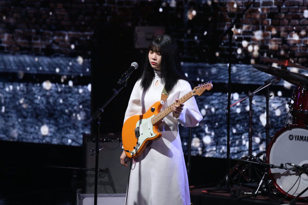 OurR's lead singer and guitarist Hong Dahye performing at a concert